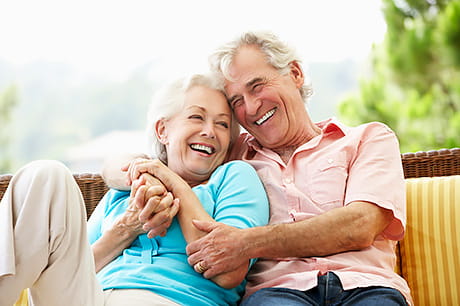 A happy retired couple enjoys time together in the outdoors.