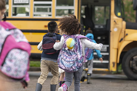 child running to bus first time after covid regulations are lifted 