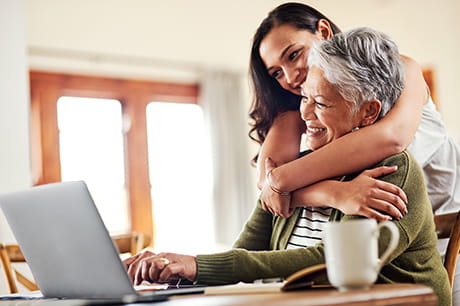 Daughter helping mother sign up for insurance