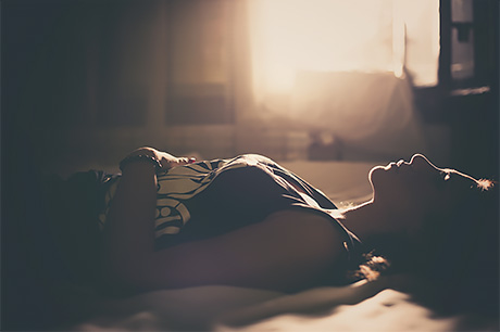 Woman laying on her bed