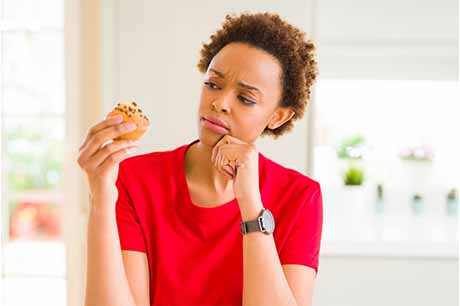 Woman looking at a muffin