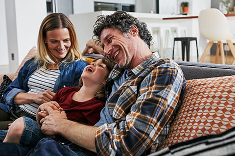Happy family laughing on the couch
