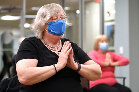 A woman practices a meditative exercise at a Geisinger 65Forward location.