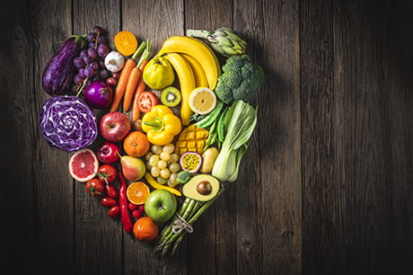 an image of various fruits and vegetables in the shape of a heart