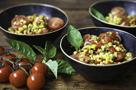 Fresh corn salad with tomatoes and basil