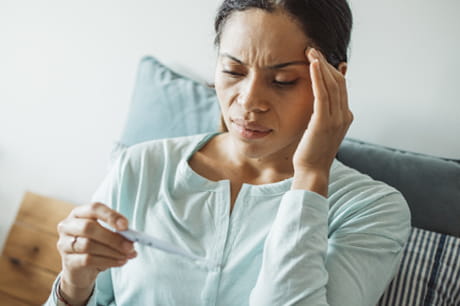 Woman taking her temperature