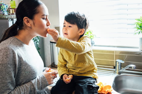 A child giving food to his parent