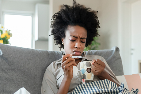 an image of a woman looking at a thermometer reading