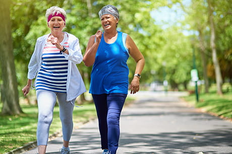 Image of two elderly ladies walking together