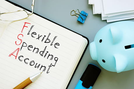 Image of a note that says flexible spending account and a blue piggy bank 