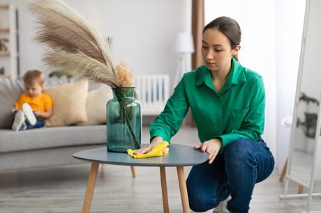 A woman cleaning with a child