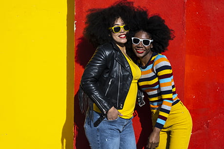 an image of two woman dressed in bright fun colors