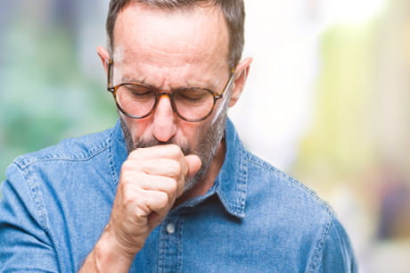 an image of a man coughing