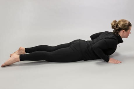 Woman practicing yoga doing a cobra pose