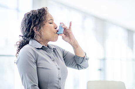 Woman using inhaler