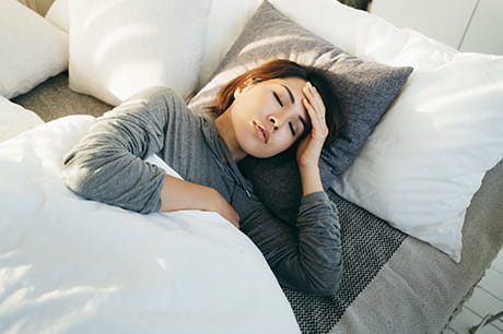 Woman in bed not feeling well