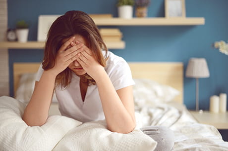 Woman in bed with a headache