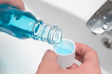 individual pouring mouth wash to use