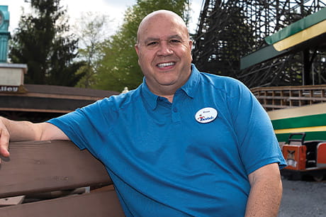 Brian Knoebel sits on a park bench in his family-owned amusement park in Elysburg, PA.