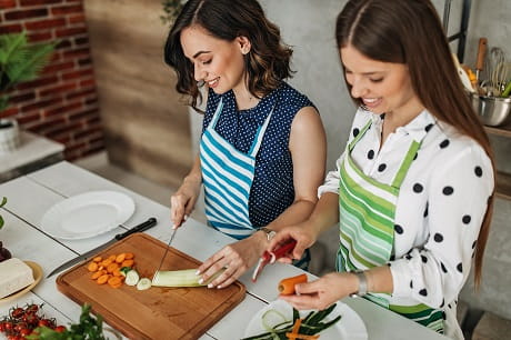Women cutting vegetables
