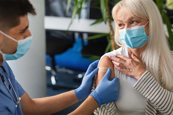 A middle-aged woman receives an RSV vaccination from her healthcare provider.