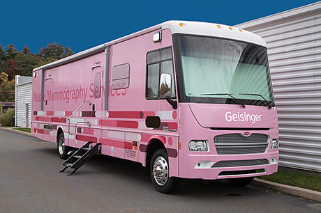 A pink Geisinger bus offers mobile mammography services for rural patients.