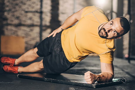 A man performs a plan maneuver at the local gym.