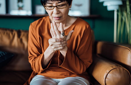 A woman rubbing her painful hands