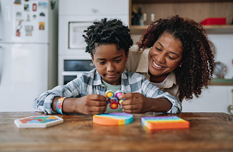 Mother playing with autistic son