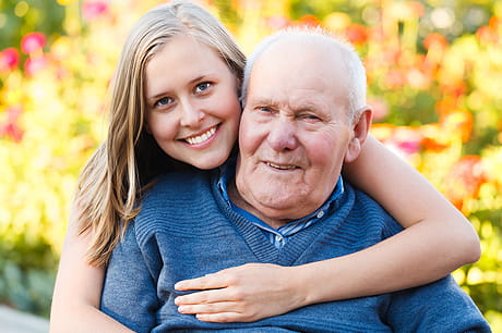 Volunteer hugging older patient