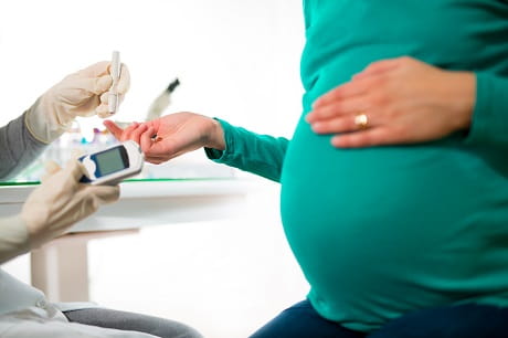 Pregnant women touches belly
