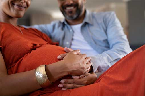 close up of couple holding pregnant belly