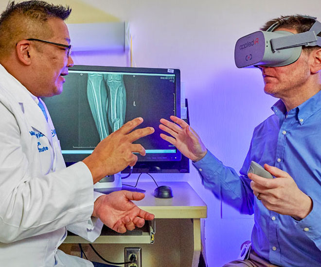 Researcher and study subject using an occulus