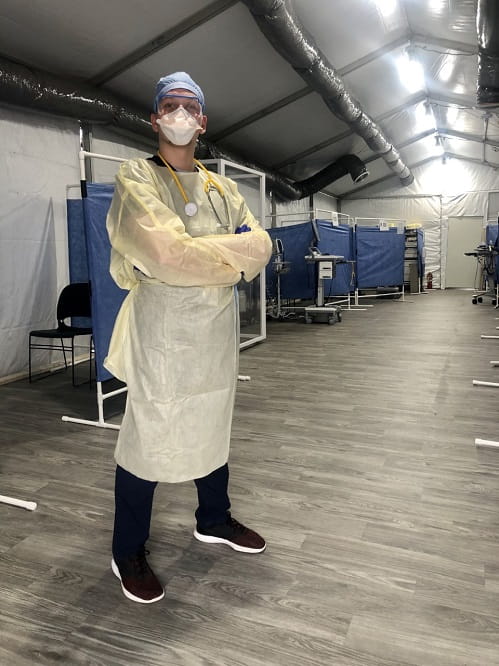 Corey Rossi, certified physician assistant, screens patients for COVID-19 in tents outside the hospitals’ Emergency Department.