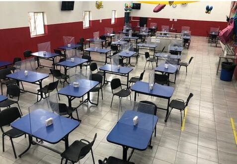Barriers on cafeteria tables allow employees at InterMetro in Wilkes-Barre to sit and eat together while practicing social distancing.