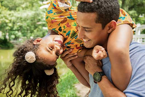 Father and daughter playing in a garden