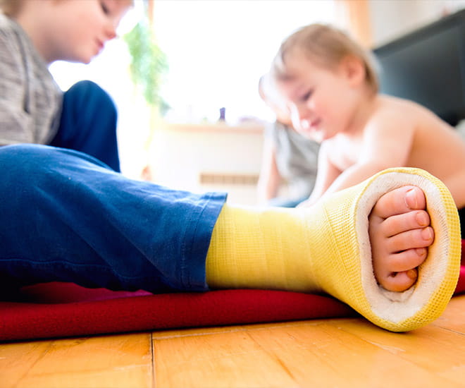 Child with a yellow cast on foot