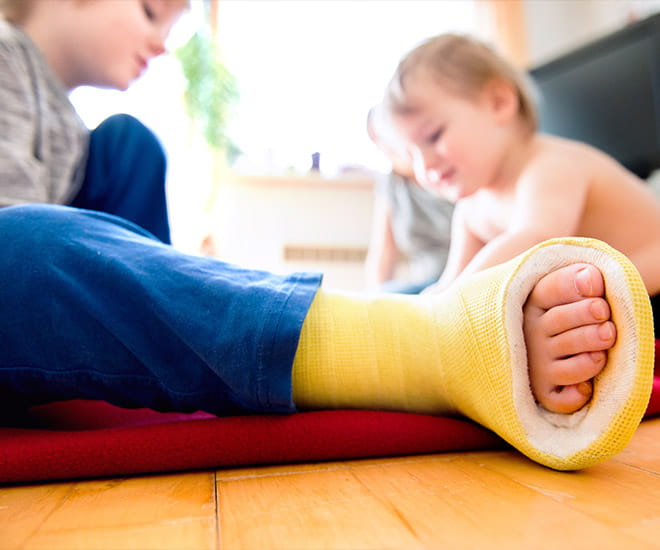 Child with a yellow cast on foot 