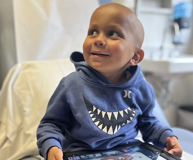 A young patient receives care for pediatric cancer.