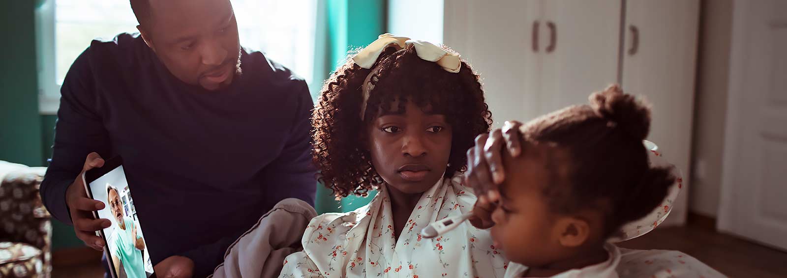 Parents with sick child use a virtual visit with a pediatric specialist.