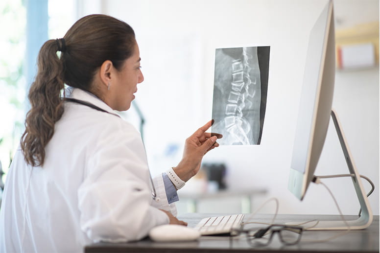 femle doctor looking at x ray