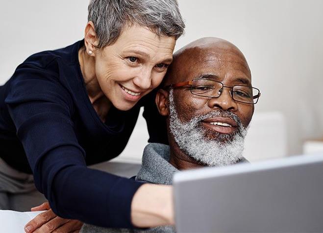 Shot of an affectionate senior couple using a laptop together while relaxing on the sofa at home