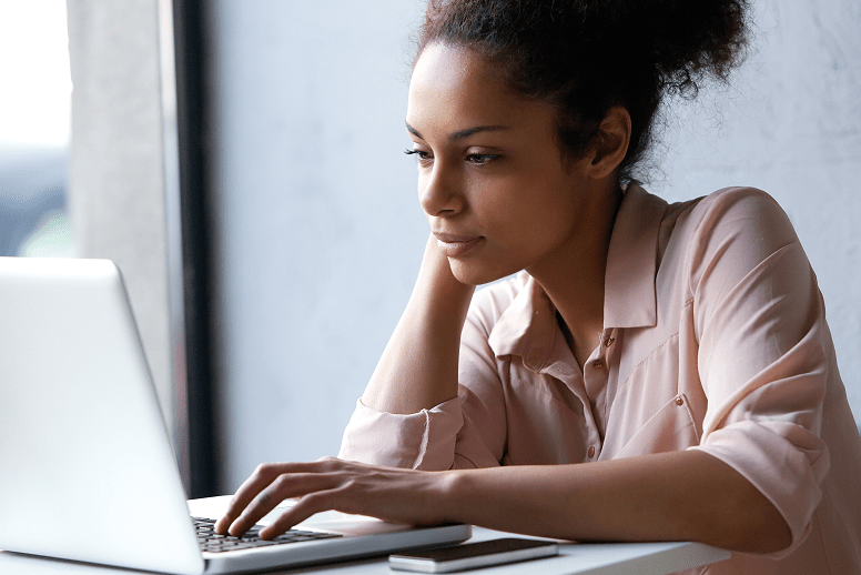 Young woman using laptop to learn about MyCode Community Health Initiative