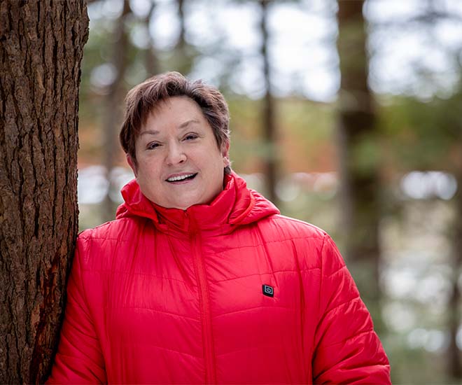 Woman standing next to tree