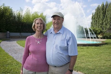 husband and wife in front of fountain
