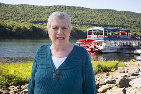 woman standing in front of river