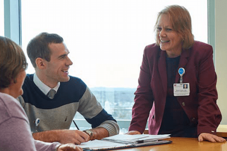 Three people in an office meeting