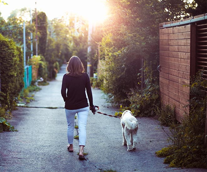 Woman walking her dog alone