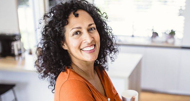 Woman in an orange shirt smiling