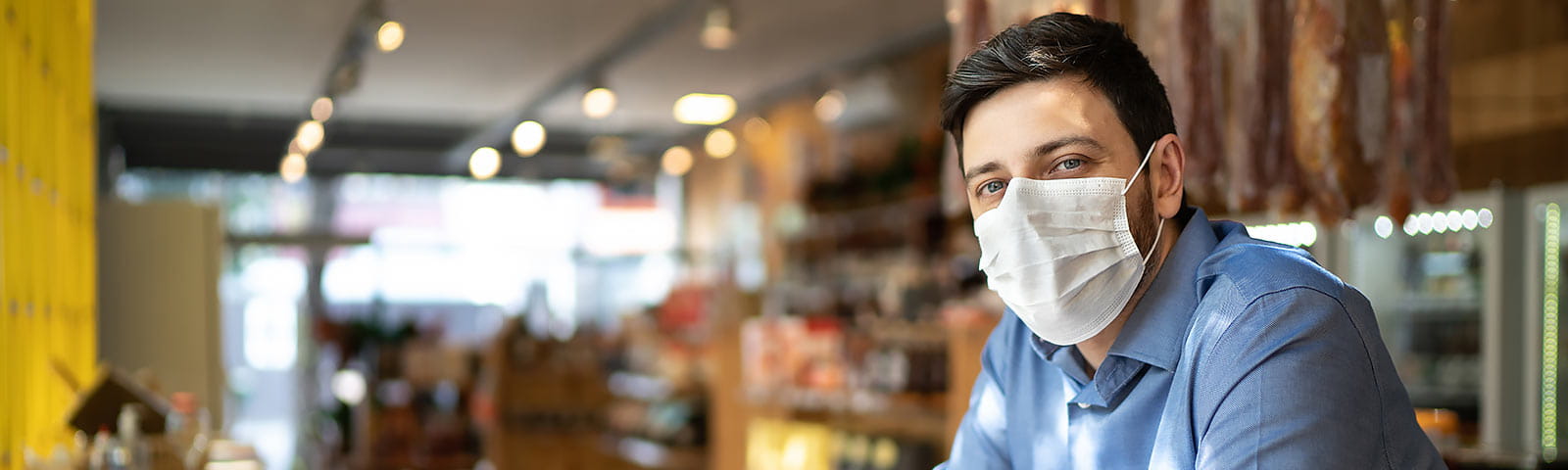 Business owner wearing protective mask to prevent the spread of COVID-19